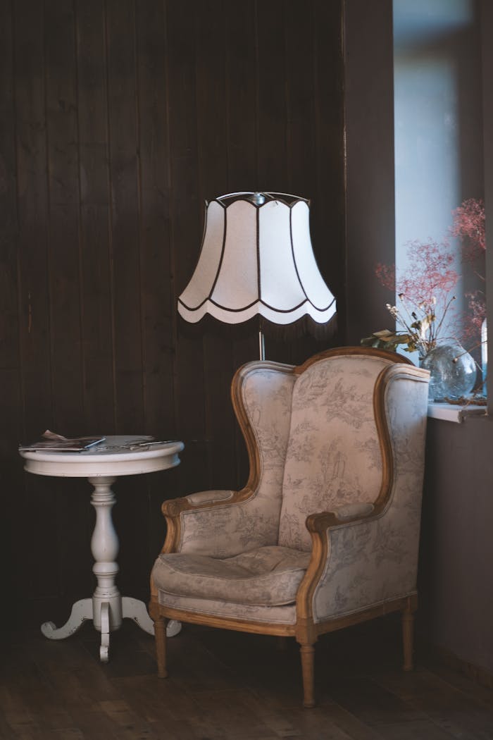 services-bg Charming vintage interior with an armchair, elegant lamp, and side table. Perfect for cozy settings.