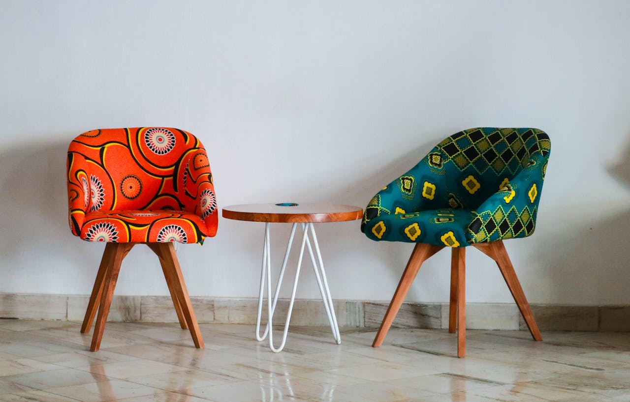 home-hero Brightly colored modern chairs and table in a minimalist room for vibrant decor ideas.